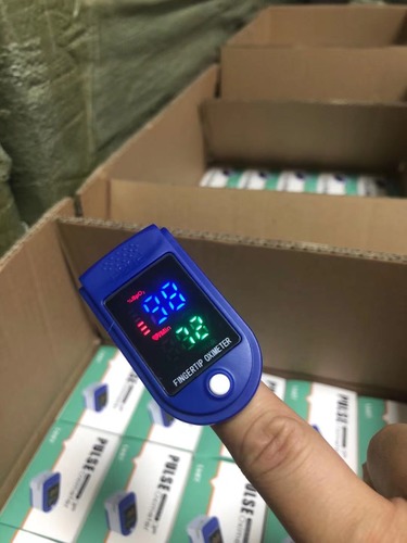 Fingertip pulse oximeter with LED screen.